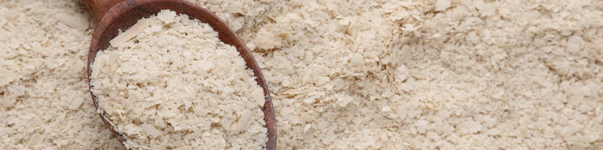 Wooden,Spoon,Of,Brewer`s,Yeast,On,Flakes,,Top,View